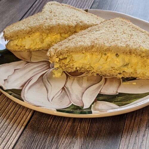 Egg salad on wheat bread cut into triangles